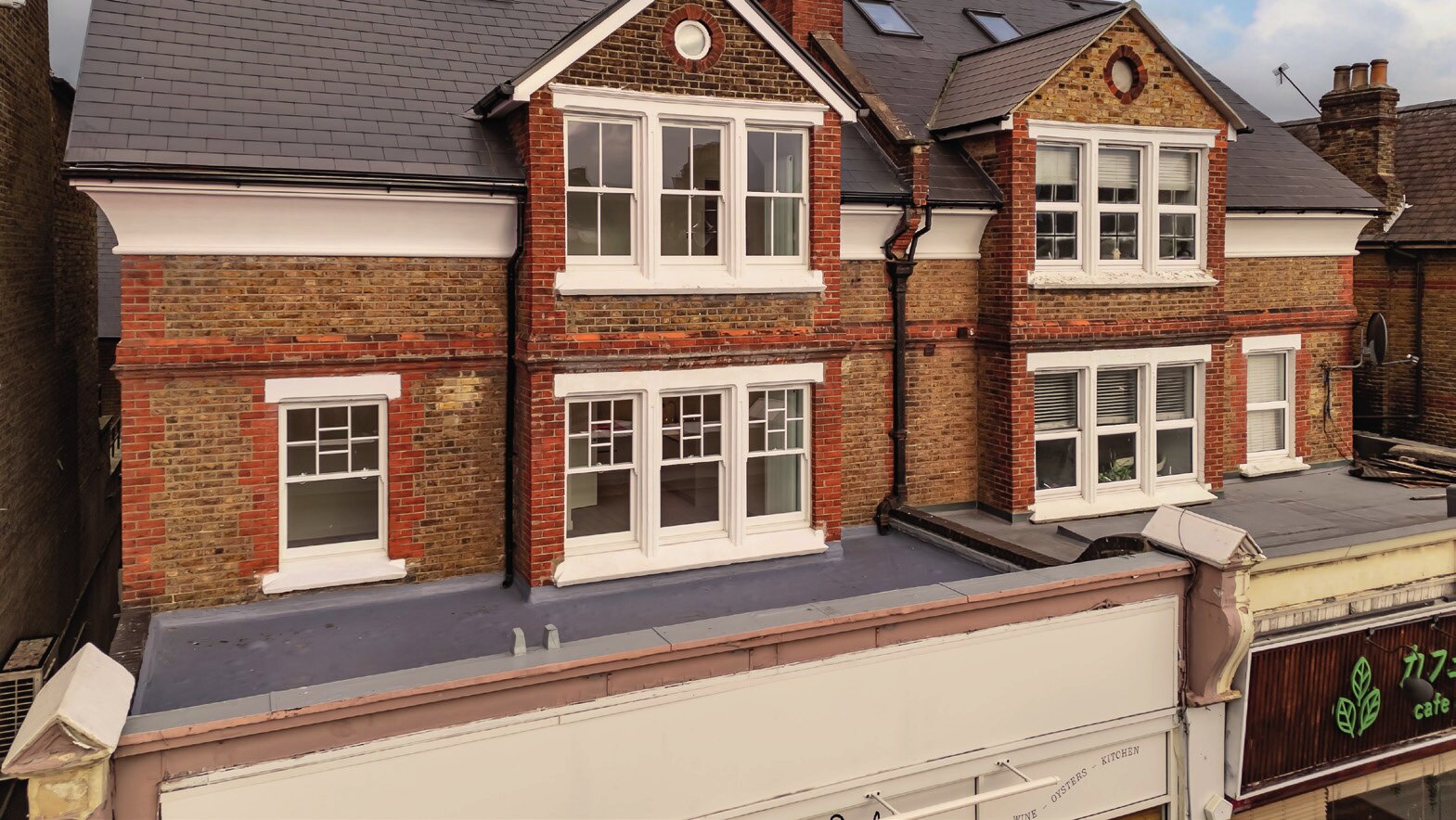 Ace Court's brick exterior and upper-floor apartments on The Broadway